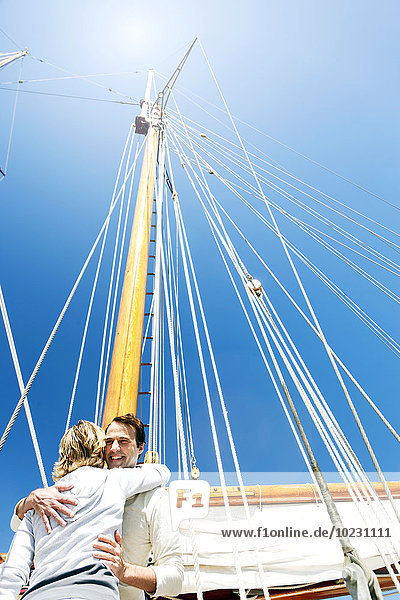 Happy mature couple hugging on a sailing ship