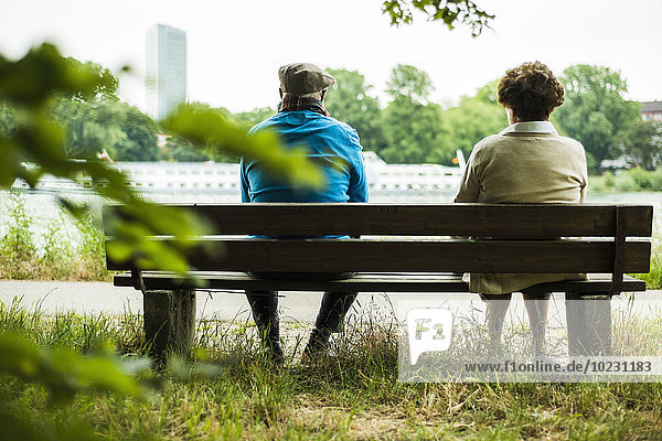 Back view of senior couple sitting on a bench