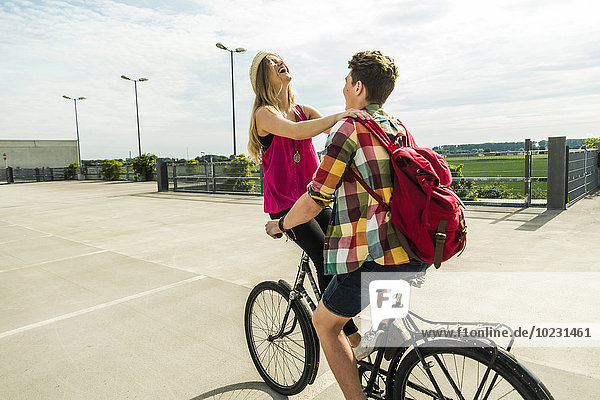 Happy young couple together on a bicycle