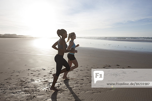 South Africa  Cape Town  two women jogging on the beach