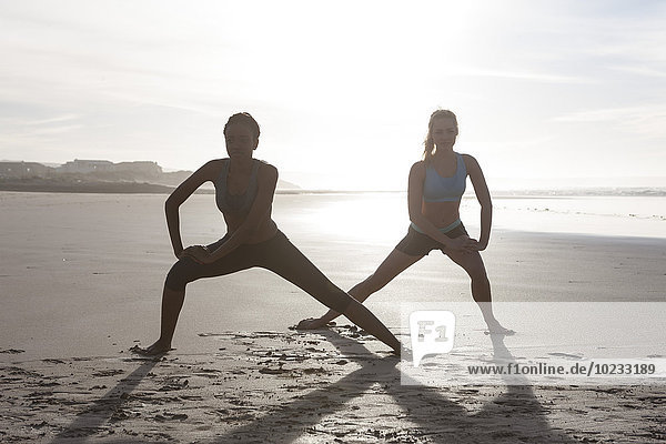 Südafrika  Kapstadt  zwei Frauen beim Stretching am Strand