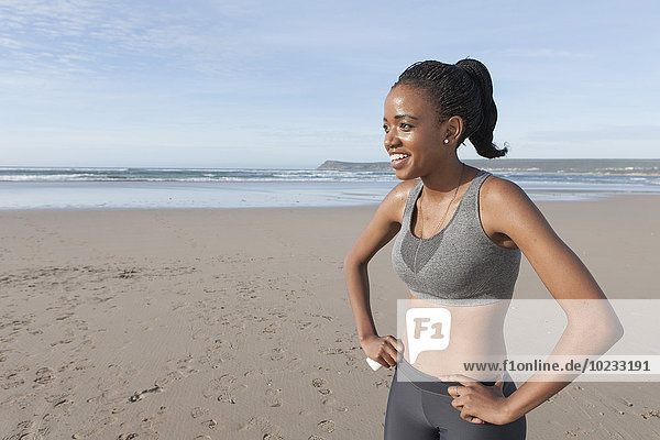 South Africa  Cape Town  smiling young jogger on the beach