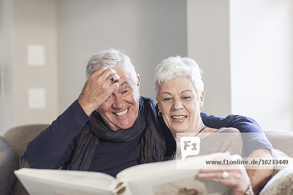 Senior couple watching photo album together