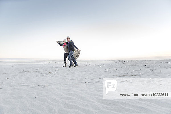 South Africa  Cape Town  senior couple walking on the beach