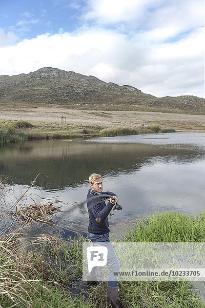 Young man fishing at a lake