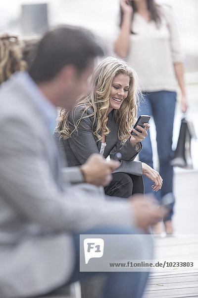 Portrait of smiling woman with smartphone