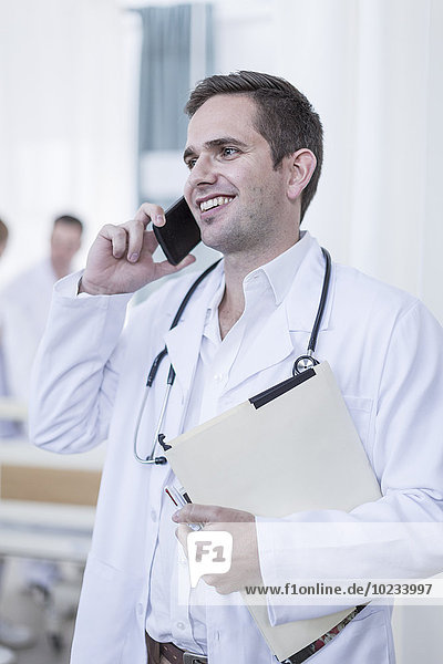 Smiling doctor in hospital on the phone