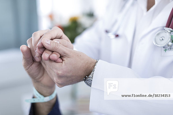 Doctor holding patient's hand  close-up