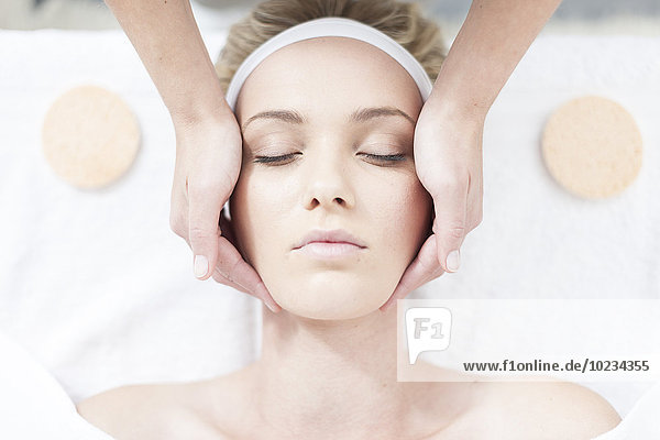 Cosmetician giving facial massage