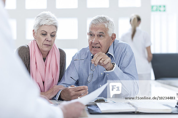 Senior couple consulting doctor