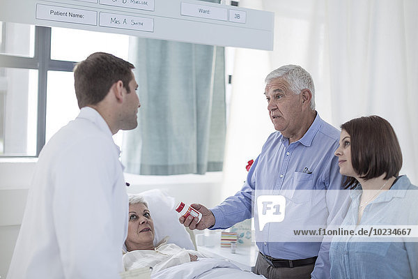 Family and doctor visiting patient in hospital