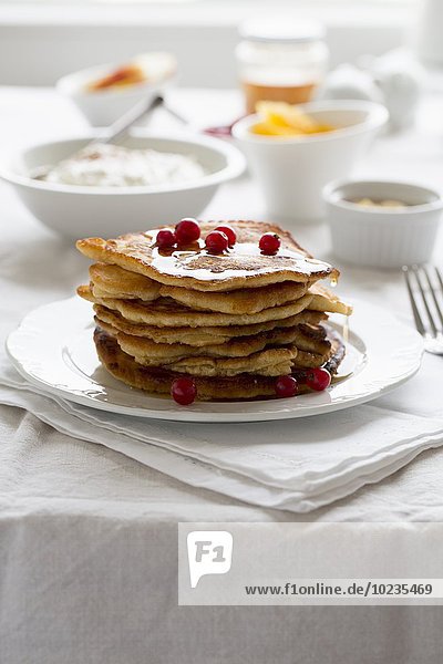 A stack of pancakes with redcurrants