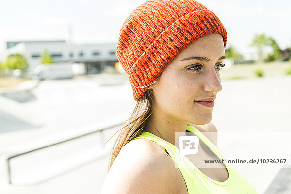Portrait of young woman wearing orange woolly hat