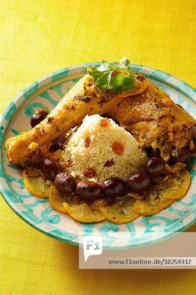 Chicken with olives and confit citrus semolina with raisins