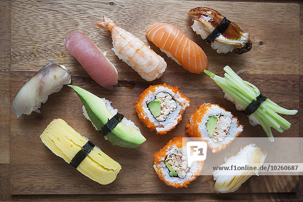 High angle view of various sushi on cutting board
