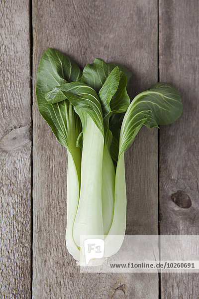 Directly above of bok choy on wooden table
