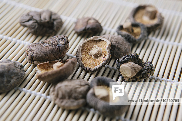 Close-up of dried mushrooms on bamboo mat