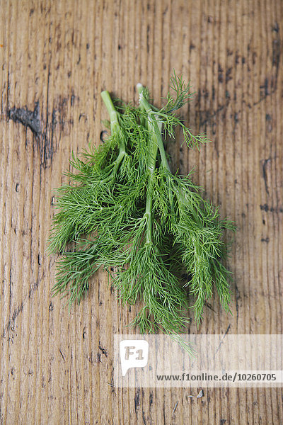 High angle view of dill leaves on wooden table
