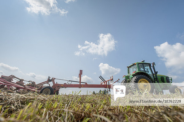 Tractor tedding hay; Sudlersville  Maryland  United States of America