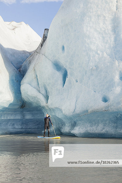 One Person stand up paddleboarding in front of Grewingk Glacier  Kachemak Bay State Park  Southcentral Alaska
