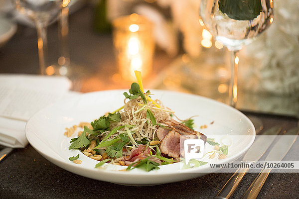 Close-up of beef and noodle salad with nuts on dinner plate  fine dining at restaurant  Canada
