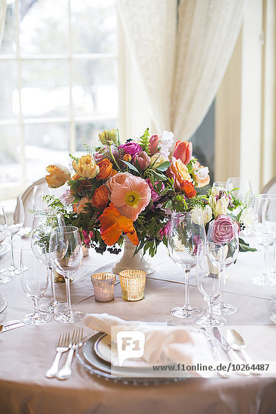 Place Settings and Floral Centerpiece on Table by Window