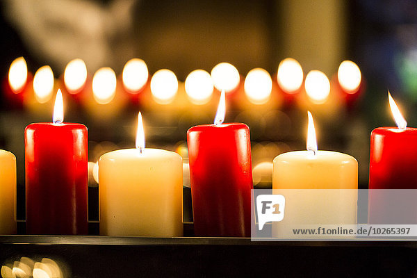 Close-up of Red and White Lit Candles