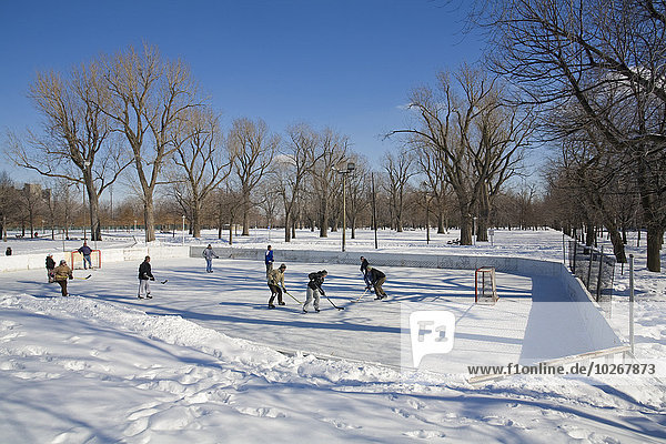 People Playing Ice Hockey In A Park