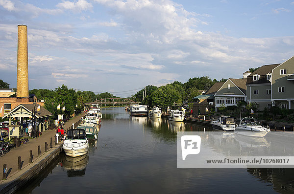Small private and charter boats tied up along canal wall  looking East; Fairport  New York  United States of America