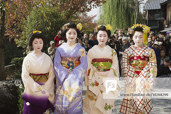 Geishas at a small festival; Kyoto  Japan