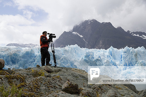 Videographer In Front Of The San Rafael Glacier  Laguna San Rafael National Park  Aysen Region  Chile