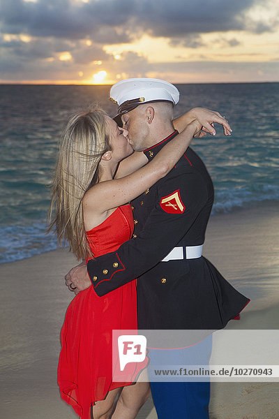 Marine and his lady getting engaged on the beach; Kailua  Island of Hawaii  Hawaii  United States of America