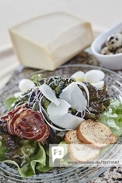 'Salad with shaved parmesean cheese  bacon  bread crisps  and quail eggs; Ontario  Canada'