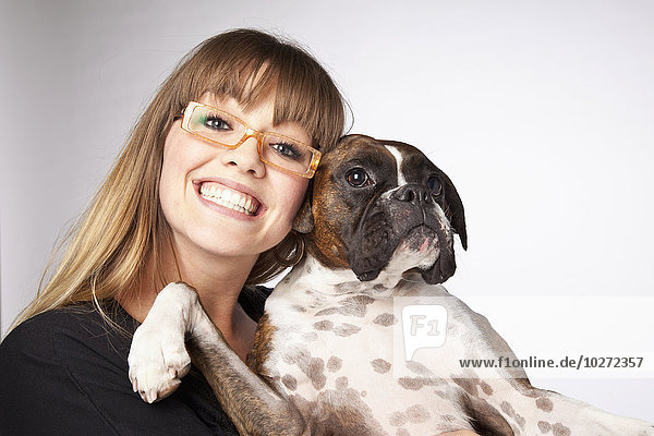 'Portrait of a young woman with her boxer dog; Edmonton  Alberta  Canada'