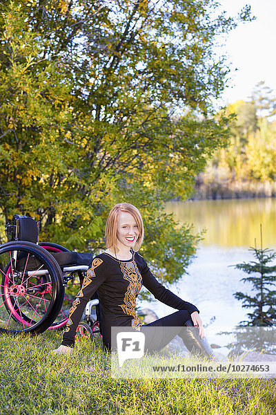 'Portrait of a young disabled woman in a city park in autumn; Edmonton  Alberta  Canada'