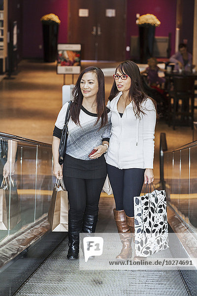 'Two girlfriends out shopping together in a shopping mall; St. Albert  Alberta  Canada'