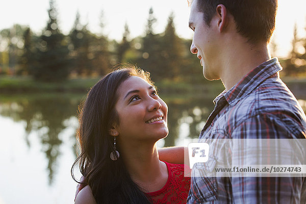 'Mixed race couple spending quality time together in a park in autumn; St. Albert  Alberta  Canada'