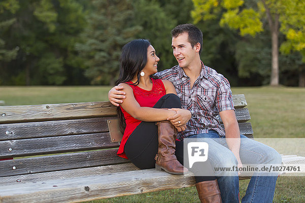 'Mixed race couple spending quality time together in a park in autumn; St. Albert  Alberta  Canada'