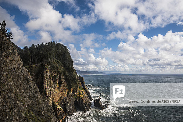 'Scattered clouds pass over the Oregon coast; Manzanita  Oregon  United States of America'