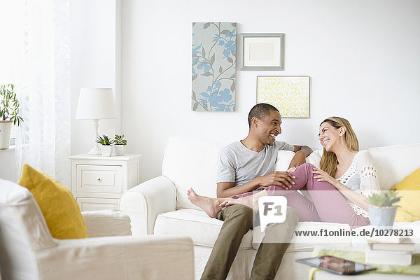 Mid adult couple relaxing in living room