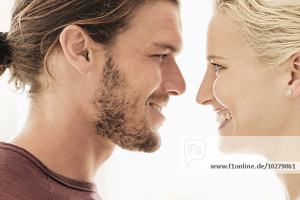 Couple face to face on white background
