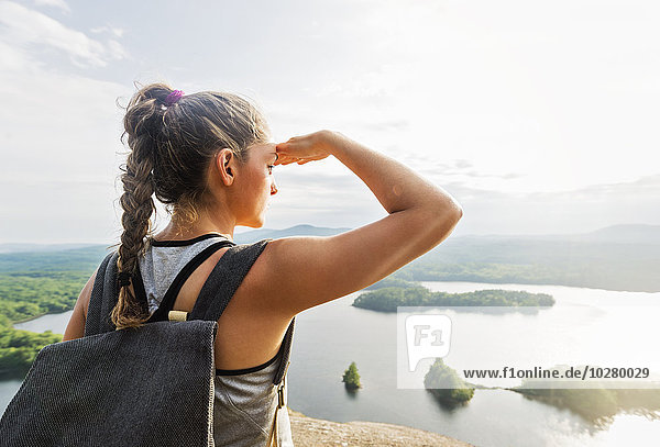 Rear view of young woman looking at view of lake