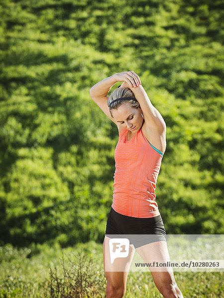 Woman exercising in field