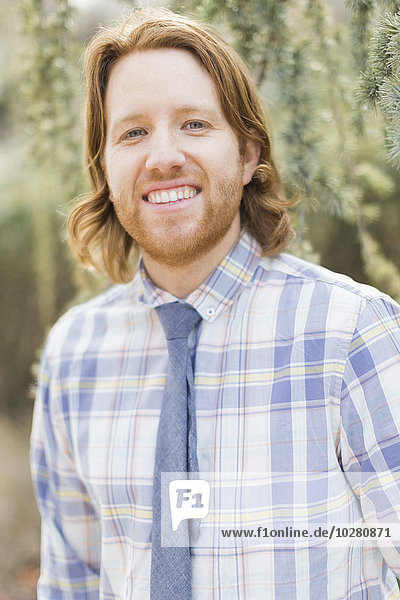 Portrait of smiling man wearing plaid shirt