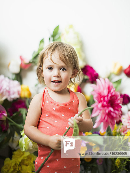 Portrait of little girl (2-3) with flower