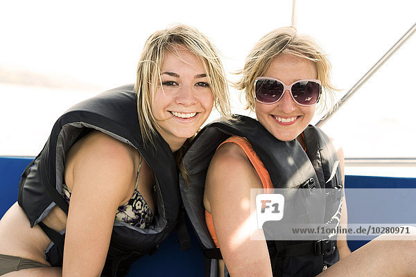 Two young women wearing life jackets