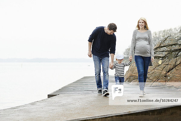 Family with son walking on jetty