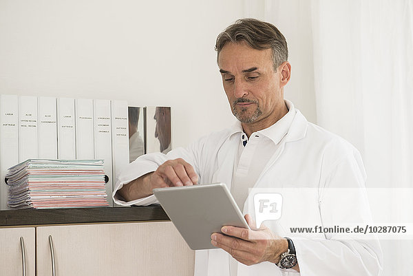 Male doctor using digital tablet in clinic  Munich  Bavaria  Germany
