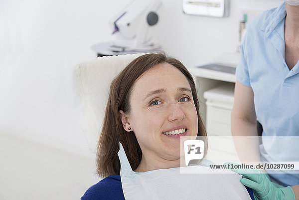 Happy patient with dental assistant in medical examination room  Munich  Bavaria  Germany