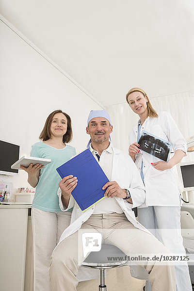 Portrait of male dentist with his medical team  Munich  Bavaria  Germany